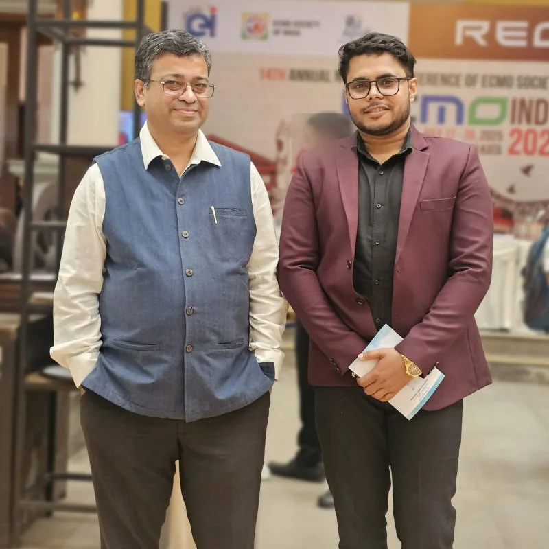 Dr. Dipanjan Chatterjee beside a Medmatis team member holding a printed copy of Rules Before Reach, at ECMO India 2025
