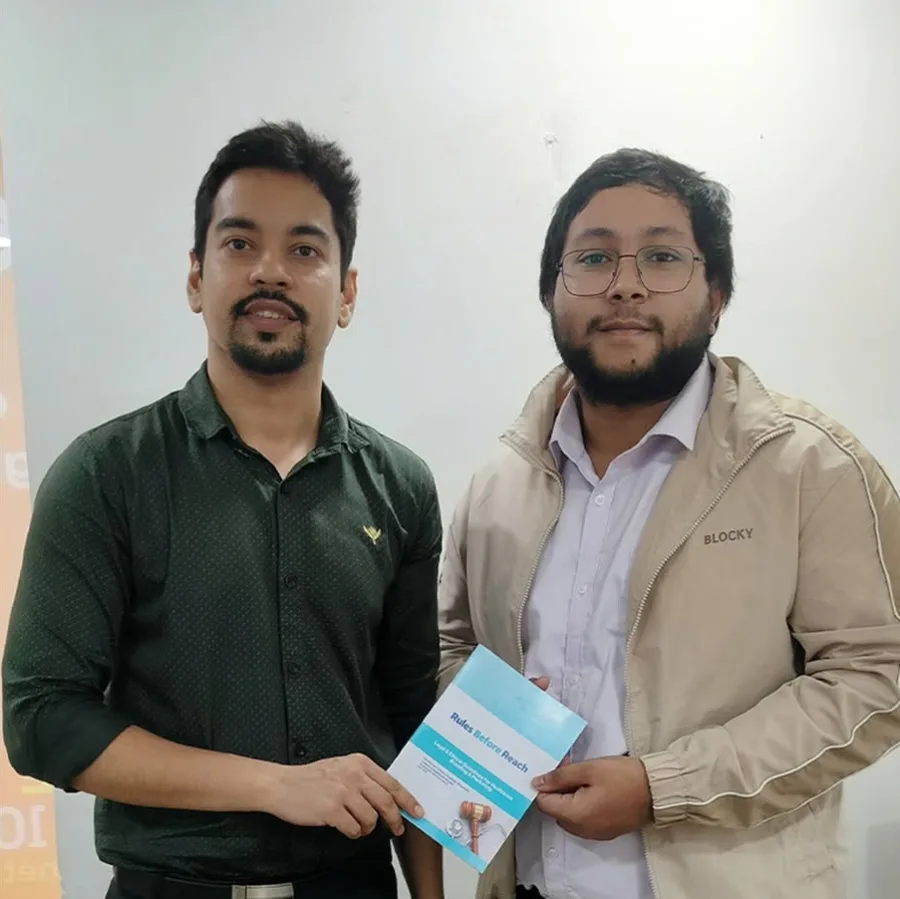 Dr. Gaurav Taparia and a Medmatis team member holding a printed copy of Rules Before Reach together