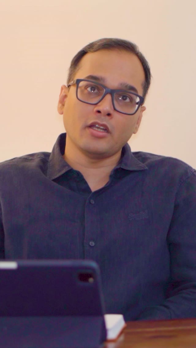 Dr. Israrul Haque speaking to camera in a dark shirt