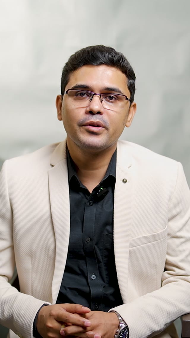 Dr. Palas De speaking to camera in a cream blazer