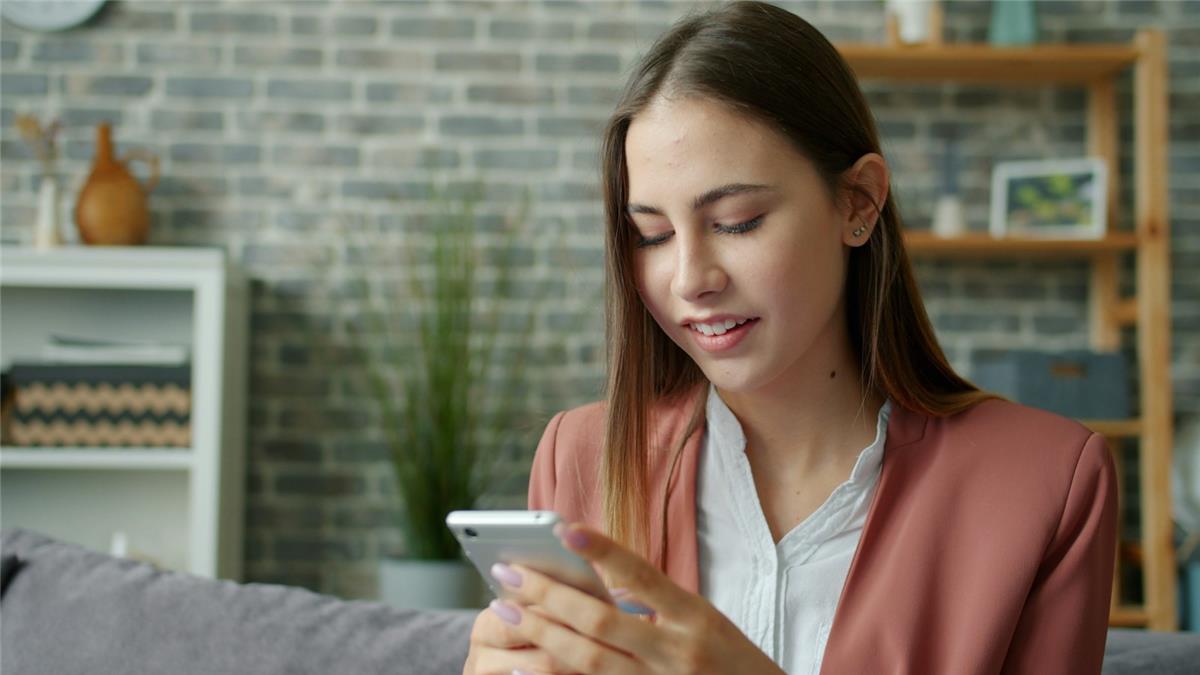 A young woman looking at her phone while searching for a doctor